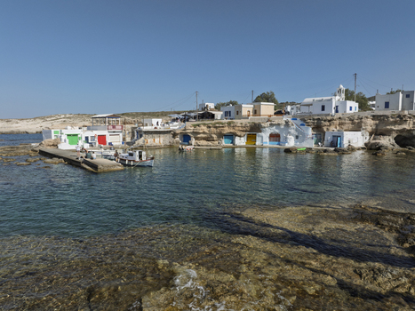 Aerial view of the traditional colorful boat houses known as syrmata carved into the volcanic rock along the turquoise coastline of Milos Greece. Aerial view of the traditional colorful boat houses known as syrmata carved into the volcanic rock along the turquoise coastline of Milos Greece.