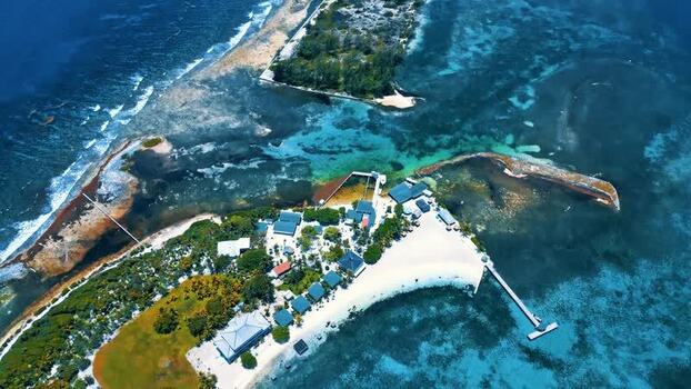 Aerial view of Guanaja island with turquoise waters and reefs Honduras.