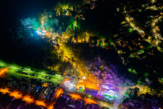 Aerial view of the Annafest festival at night with colorful amusement rides and bright lights nestled in a wooded area Forchheim Bayern Germany. Aerial view of the Annafest festival at night with colorful amusement rides and bright lights nestled in a wooded area Forchheim Bayern Germany.