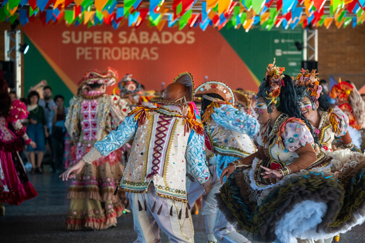 Rio de Janeiro Brazil 20 June 2026 View of Festa Junina dancers in traditional colorful costumes performing at a festive event with decorative flags overhead. Rio de Janeiro Brazil 20 June 2026 View of Festa Junina dancers in traditional colorful costumes performing at a festive event with decorative flags overhead.