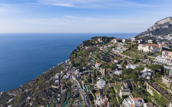 Aerial view of coastal buildings cascading down the rugged cliffs towards the turquoise sea charmingly nestled in nature Ravello Salerno Italy Aerial view of coastal buildings cascading down the rugged cliffs towards the turquoise sea charmingly nestled in nature Ravello Salerno Italy