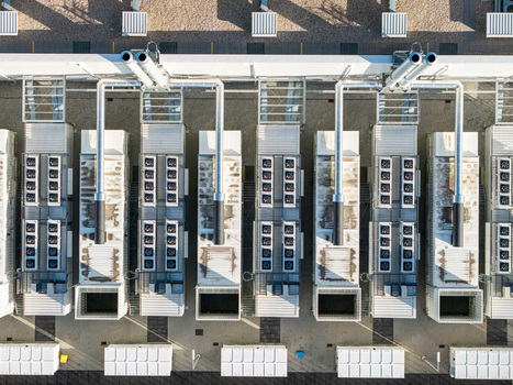 Aerial view of the Vantage Data Centers BER1 facility featuring rows of industrial cooling units and HVAC systems on the rooftop in Ludwigsfelde Brandenburg Germany. Aerial view of the Vantage Data Centers BER1 facility featuring rows of industrial cooling units and HVAC systems on the rooftop in Ludwigsfelde Brandenburg Germany.