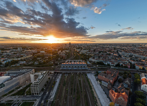 Aerial view of Ostkreuz railway station in Berlin at sunset with train tracks urban architecture and city skyline in Berlin Berlin Germany. Aerial view of Ostkreuz railway station in Berlin at sunset with train tracks urban architecture and city skyline in Berlin Berlin Germany.