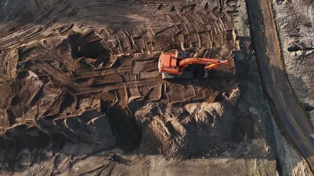 Aerial view of an orange excavator on a construction site Netherlands.