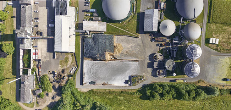Schleswig Germany 26 June 2026 Aerial view of a biogas works on an industrial site with large fermentation tanks storage silos and biomass piles. Schleswig Germany 26 June 2026 Aerial view of a biogas works on an industrial site with large fermentation tanks storage silos and biomass piles.