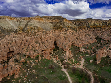 Aerial view of Zelve Vadisi with its unique fairy chimneys rock cut dwellings and winding paths through the rugged volcanic landscape in Goreme Nevsehir Turkiye. Aerial view of Zelve Vadisi with its unique fairy chimneys rock cut dwellings and winding paths through the rugged volcanic landscape in Goreme Nevsehir Turkiye.