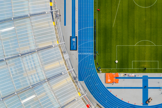 Chorzow Silesian Voivodeship Poland 17 September 2026 Aerial view of Silesian Stadium with its blue running track green football pitch and modern translucent roof structure.