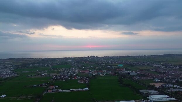 Aerial view of Mataram coastal city at sunset Indonesia.
