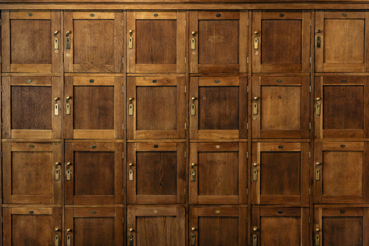 View of a grid of vintage wooden lockers with brass hardware in Gdansk Pomeranian Voivodeship Poland. View of a grid of vintage wooden lockers with brass hardware in Gdansk Pomeranian Voivodeship Poland.