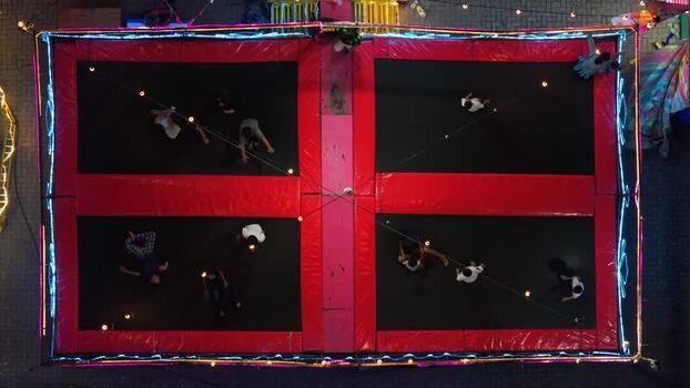 Aerial view of people jumping on trampolines at night Indonesia.