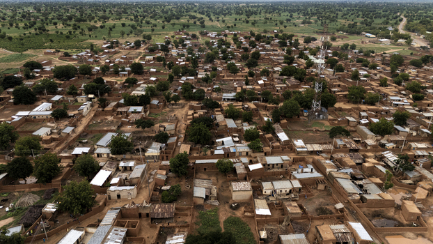 Aerial view of Dambatta town with traditional mud brick houses a tall communication tower and surrounding rural landscape in Dambatta Kano Nigeria. Aerial view of Dambatta town with traditional mud brick houses a tall communication tower and surrounding rural landscape in Dambatta Kano Nigeria.