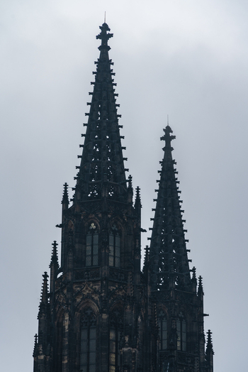 View of the gothic spires rising against a cloudy sky Prague Czechia.