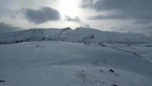 Aerial view of snowy mountains on Kvaloya island Norway.