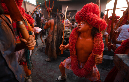 Munshiganj Bangladesh 13 April 2025 View of vividly painted figures in crimson garlands and wooden swords performing a spirited cultural ritual. Munshiganj Bangladesh 13 April 2025 View of vividly painted figures in crimson garlands and wooden swords performing a spirited cultural ritual.