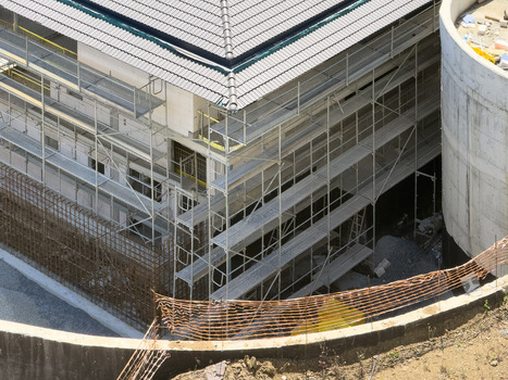 View of a modern building under construction with extensive metal scaffolding and a dark tiled roof in Avcilar Istanbul Turkiye. View of a modern building under construction with extensive metal scaffolding and a dark tiled roof in Avcilar Istanbul Turkiye.