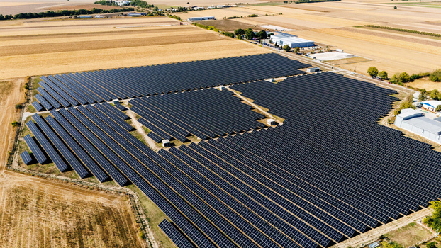 Aerial view of a large solar farm with rows of photovoltaic panels installed in a rural landscape in Temerin Vojvodina Serbia. Aerial view of a large solar farm with rows of photovoltaic panels installed in a rural landscape in Temerin Vojvodina Serbia.