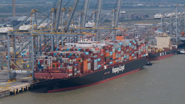 Corringham England United Kingdom 10 July 2026 Aerial view of Solent Stevedores London Gateway with a Hapag Lloyd container ship docked at the terminal cranes and shipping containers.