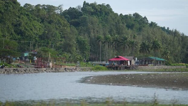 View of a coastal building with a red roof and forest Bangladesh.