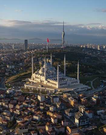 Aerial view of the Grand Camlica Mosque with its prominent domes and minarets rising above the dense urban landscape of Uskudar Istanbul Turkiye. Aerial view of the Grand Camlica Mosque with its prominent domes and minarets rising above the dense urban landscape of Uskudar Istanbul Turkiye.