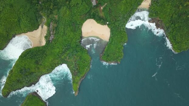 Aerial view of Sedahan Beach and rocky cliffs Indonesia.