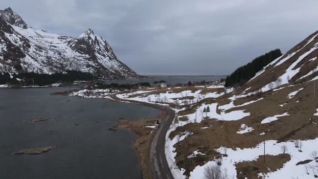 Aerial view of Lofoten mountains and coastal road Norway.