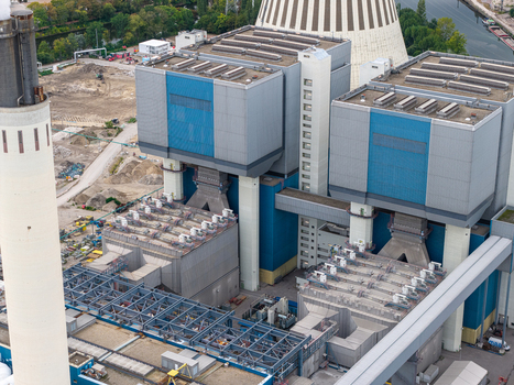 Aerial view of Heizkraftwerk Reuter West a combined heat and power plant featuring large industrial structures and cooling towers in Berlin Berlin Germany.