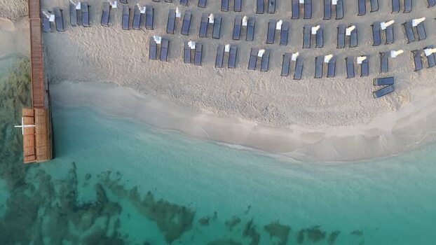 Aerial view of beach with sun loungers in Albania.