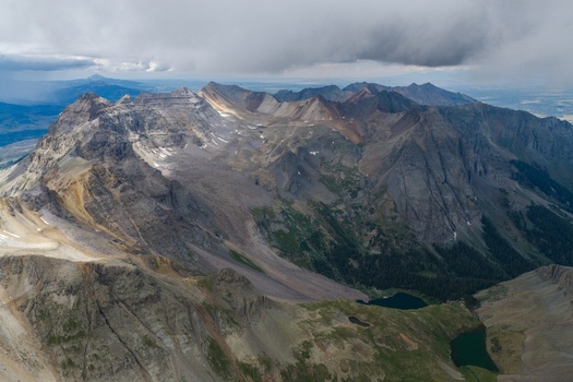 Aerial view of Mount Sneffels and the rugged peaks of the San Juan Mountains with alpine lakes in Yankee Boy Basin Ouray County Colorado United States. Aerial view of Mount Sneffels and the rugged peaks of the San Juan Mountains with alpine lakes in Yankee Boy Basin Ouray County Colorado United States.