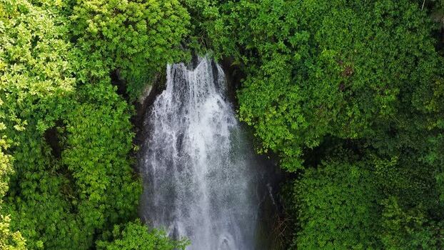 Aerial view of waterfall in tropical forest Indonesia.