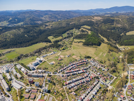 Aerial view of town buildings and residential houses surrounded by green fields and forested hills Namestovo Zilina Region Slovakia. Aerial view of town buildings and residential houses surrounded by green fields and forested hills Namestovo Zilina Region Slovakia.