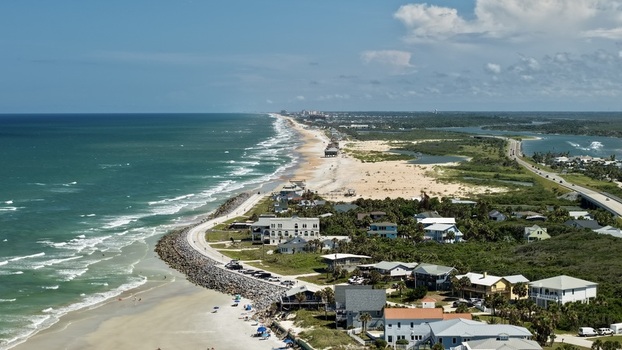 Aerial view of Matanzas Inlet showing the coastline sandy beach residential houses and the coastal road in St. Johns County Florida United States. Aerial view of Matanzas Inlet showing the coastline sandy beach residential houses and the coastal road in St. Johns County Florida United States.