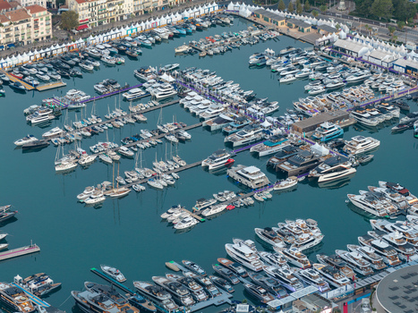 Aerial view of the marina in Cannes filled with numerous luxury yachts and boats docked at the piers showcasing the vibrant coastal atmosphere in Cannes Provence Alpes Cote d Azur France. Aerial view of the marina in Cannes filled with numerous luxury yachts and boats docked at the piers showcasing the vibrant coastal atmosphere in Cannes Provence Alpes Cote d Azur France.