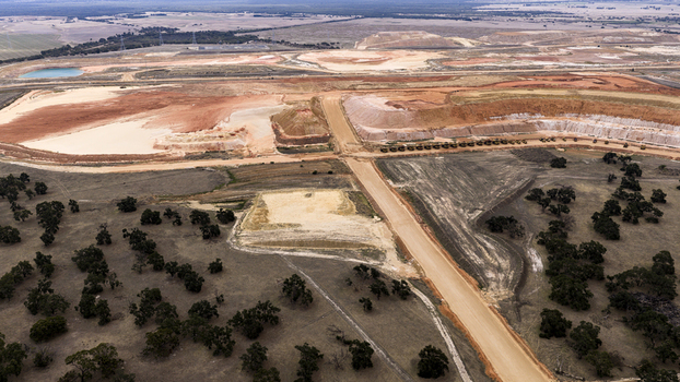 Aerial view of industrial mining site with excavated earth dirt roads and sparse vegetation in Kalbarri Western Australia Australia. Aerial view of industrial mining site with excavated earth dirt roads and sparse vegetation in Kalbarri Western Australia Australia.