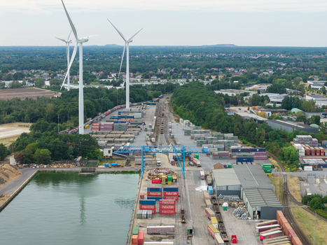Genk Belgium 27 August 2026 Aerial view of the Haven Genk inland port and container terminal featuring intermodal transport rail freight and wind turbines in an industrial landscape.