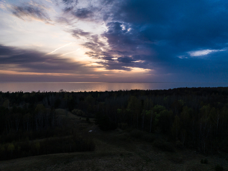 Aerial view of the coastal landscape near Perkone featuring dense forest bordering the Baltic Sea in Grinvalti South Kurzeme Municipality Latvia. Aerial view of the coastal landscape near Perkone featuring dense forest bordering the Baltic Sea in Grinvalti South Kurzeme Municipality Latvia.
