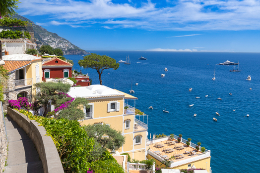 Aerial view of the colorful houses and terraces of Positano overlooking the blue Tyrrhenian Sea with boats sailing in the water Positano Campania Italy. Aerial view of the colorful houses and terraces of Positano overlooking the blue Tyrrhenian Sea with boats sailing in the water Positano Campania Italy.