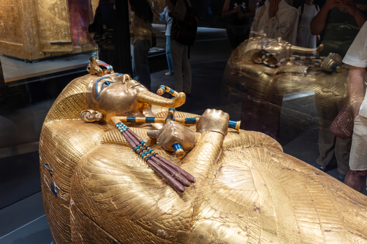 Giza Governorate Egypt 16 May 2026 View of the golden sarcophagus of Tutankhamun with intricate carvings and museum visitors in the background at The Grand Egyptian Museum. Giza Governorate Egypt 16 May 2026 View of the golden sarcophagus of Tutankhamun with intricate carvings and museum visitors in the background at The Grand Egyptian Museum.