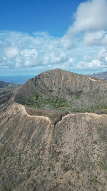 Aerial view of the rugged Koko Head volcano crater a stark contrast of dry rocky slopes against the lush green interior Honolulu Hawaii United States. Aerial view of the rugged Koko Head volcano crater a stark contrast of dry rocky slopes against the lush green interior Honolulu Hawaii United States.