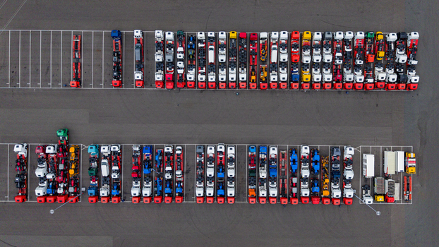 Aerial view of rows of colorful semi trucks parked in an orderly fashion on an asphalt lot at Ekkersrijt 2037 in Son Noord Brabant Netherlands.