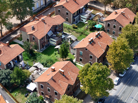 Aerial view of the historic Villaggio Leumann with its characteristic brick houses red tiled roofs and lush green gardens in Collegno Piemonte Italy. Aerial view of the historic Villaggio Leumann with its characteristic brick houses red tiled roofs and lush green gardens in Collegno Piemonte Italy.