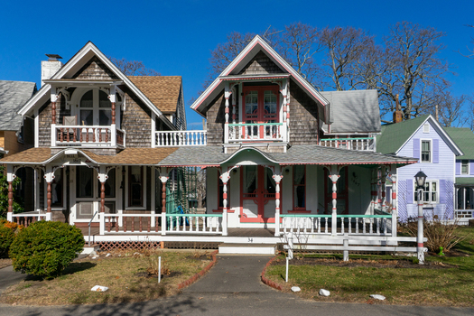 View of historic gingerbread cottages with ornate wooden trim and colorful porches on Martha s Vineyard Edgartown Massachusetts United States.
