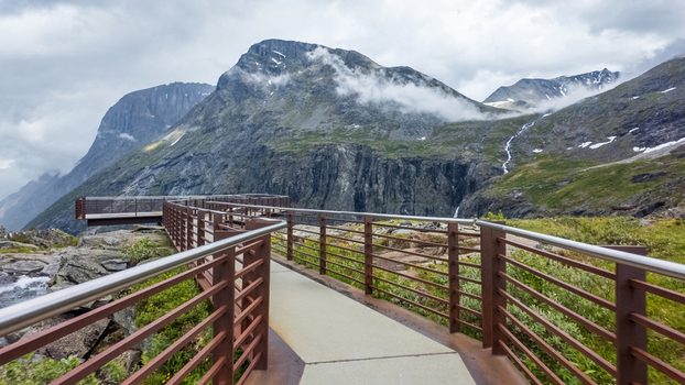 View of the Trollstigen viewpoint platform overlooking dramatic mountain peaks and misty valleys Andalsnes More og Romsdal Norway. View of the Trollstigen viewpoint platform overlooking dramatic mountain peaks and misty valleys Andalsnes More og Romsdal Norway.