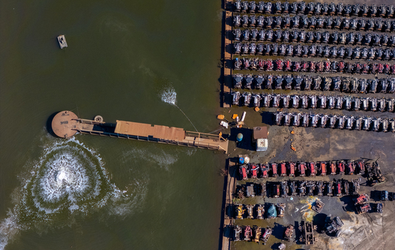 Aerial view of rows of scrapped heavy duty truck engines stored near a water treatment facility in Kalamazoo Michigan United States.