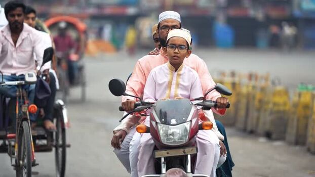 View of a man and boy on a motorcycle in Bogura Bangladesh. View of a man and boy on a motorcycle in Bogura Bangladesh.