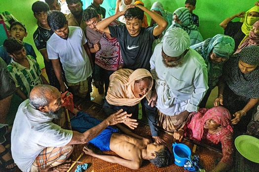 Banshkhali Upazila Chittagong Division Bangladesh 10 July 2026 View of people gathered around a person lying on the floor in distress with concerned family members in a crowded room. Banshkhali Upazila Chittagong Division Bangladesh 10 July 2026 View of people gathered around a person lying on the floor in distress with concerned family members in a crowded room.