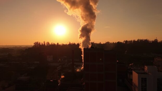 Aerial view of factory smoke at sunset in Brazil. Aerial view of factory smoke at sunset in Brazil.
