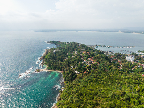 Aerial view of Secret Beach Mirissa nestled along a rocky coastline with turquoise waters and lush tropical greenery Mirissa Southern Province Sri Lanka. Aerial view of Secret Beach Mirissa nestled along a rocky coastline with turquoise waters and lush tropical greenery Mirissa Southern Province Sri Lanka.