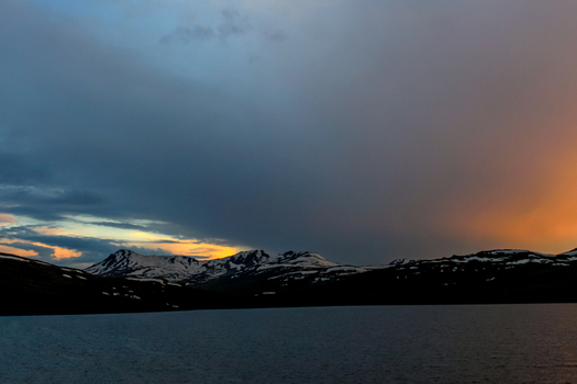 View of Sheosar Lake with snow capped mountains under a dramatic sunset sky in Skardu Pakistan. View of Sheosar Lake with snow capped mountains under a dramatic sunset sky in Skardu Pakistan.