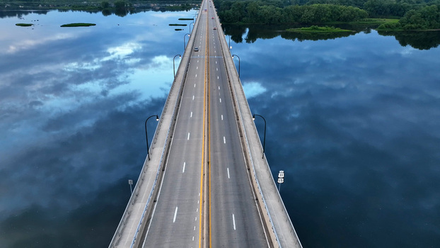 Aerial view of Harvey Taylor Bridge spanning the Susquehanna River with calm water reflecting the sky in Harrisburg Pennsylvania United States.