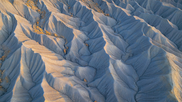 Aerial view of the eroded ridges and desert landscape of the badlands in Hanksville Utah United States.